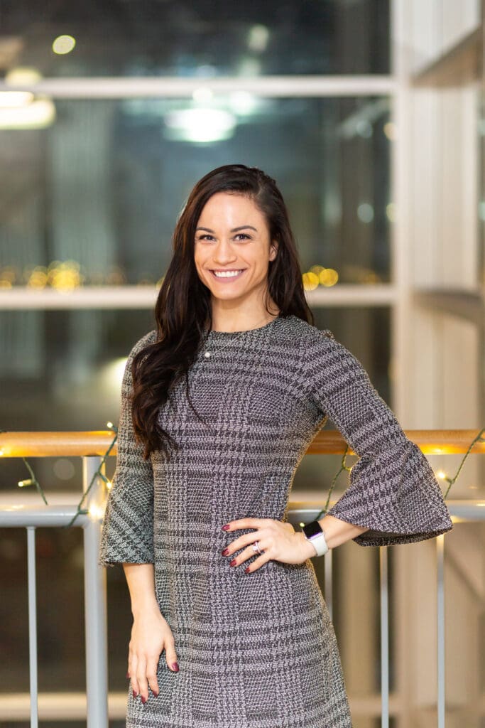 A woman standing in front of a railing.